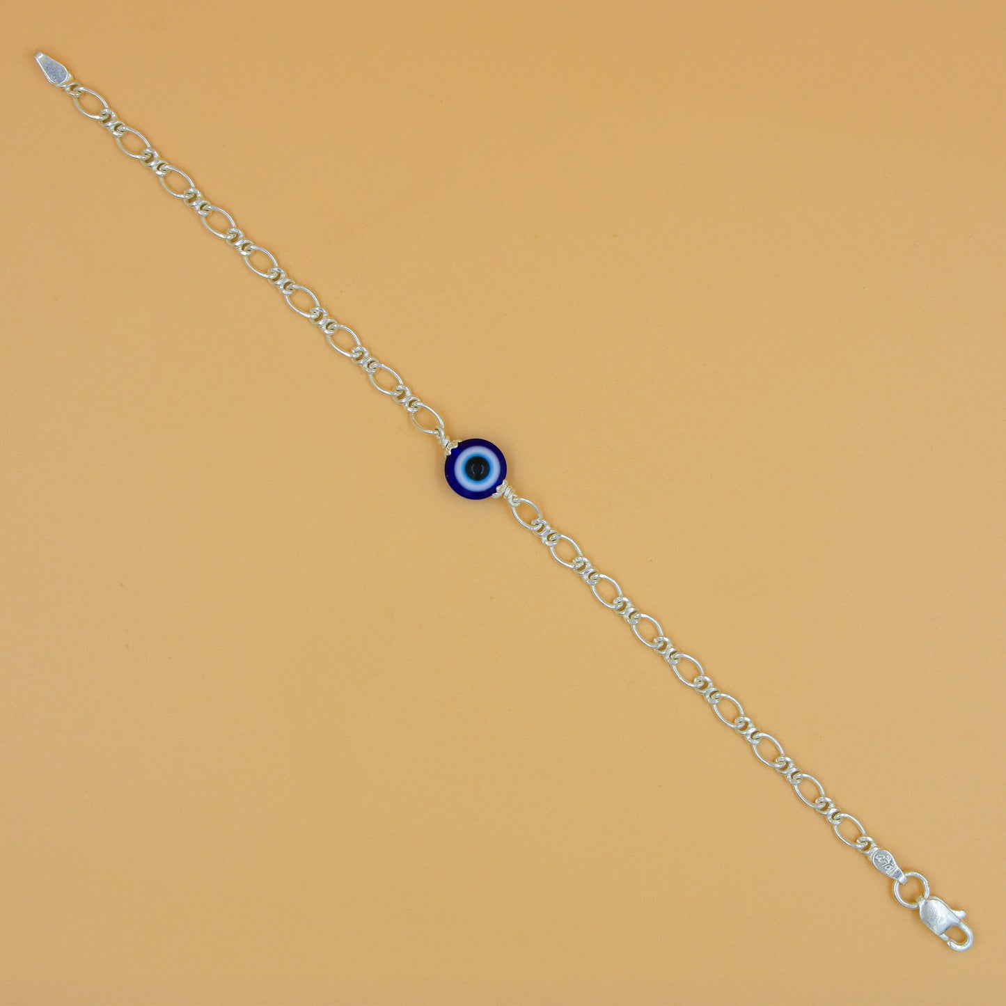 Delicate sterling silver bracelet with a protective evil eye charm