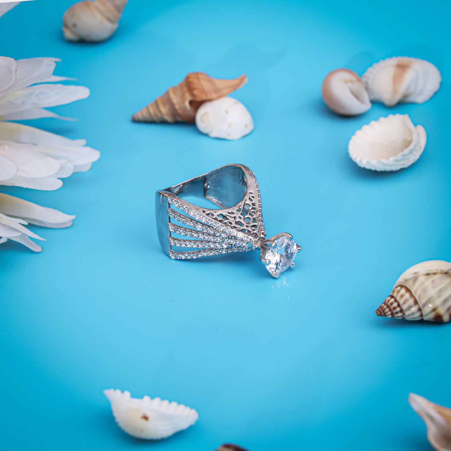 Hand-engraved silver ring featuring a shining white center stone for a distinctive look.