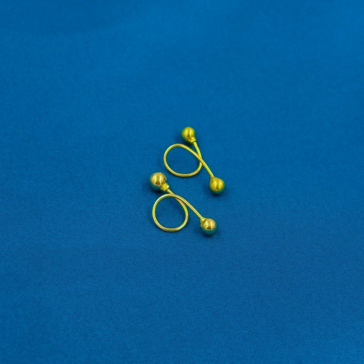 Minimalist gold-plated silver ball stud earrings for a sleek look.