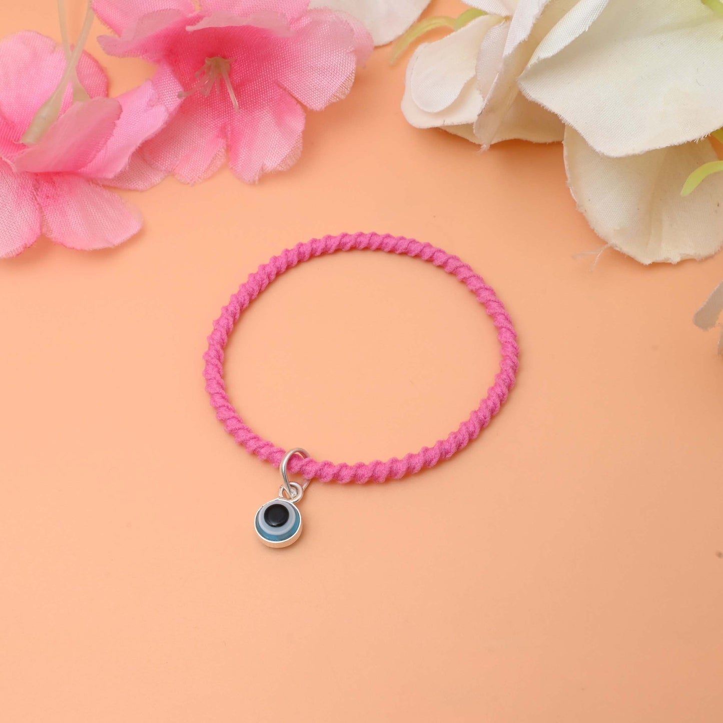 A stylish black bracelet featuring a silver evil eye charm