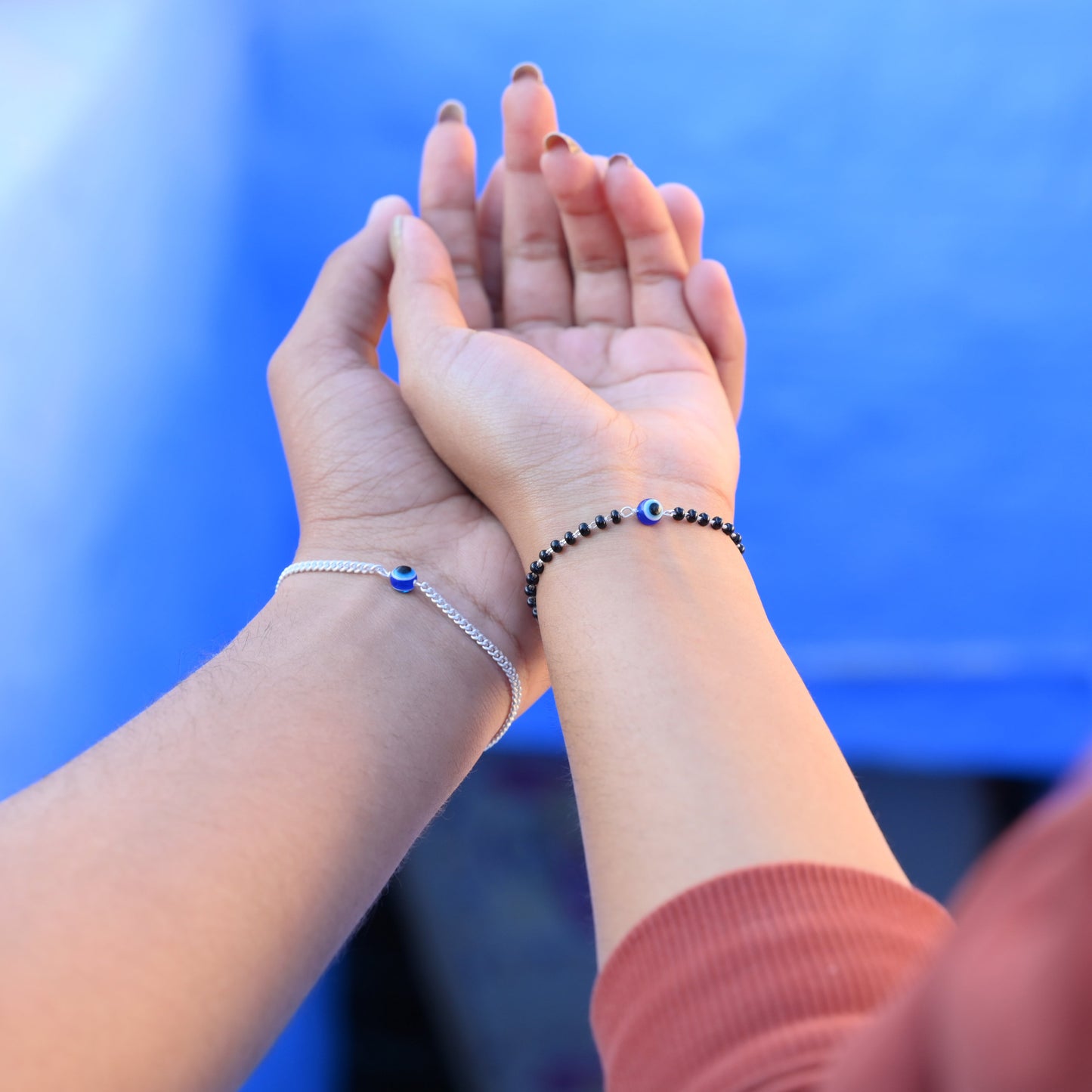 Stylish silver evil eye bracelet set for couples, offering protection.