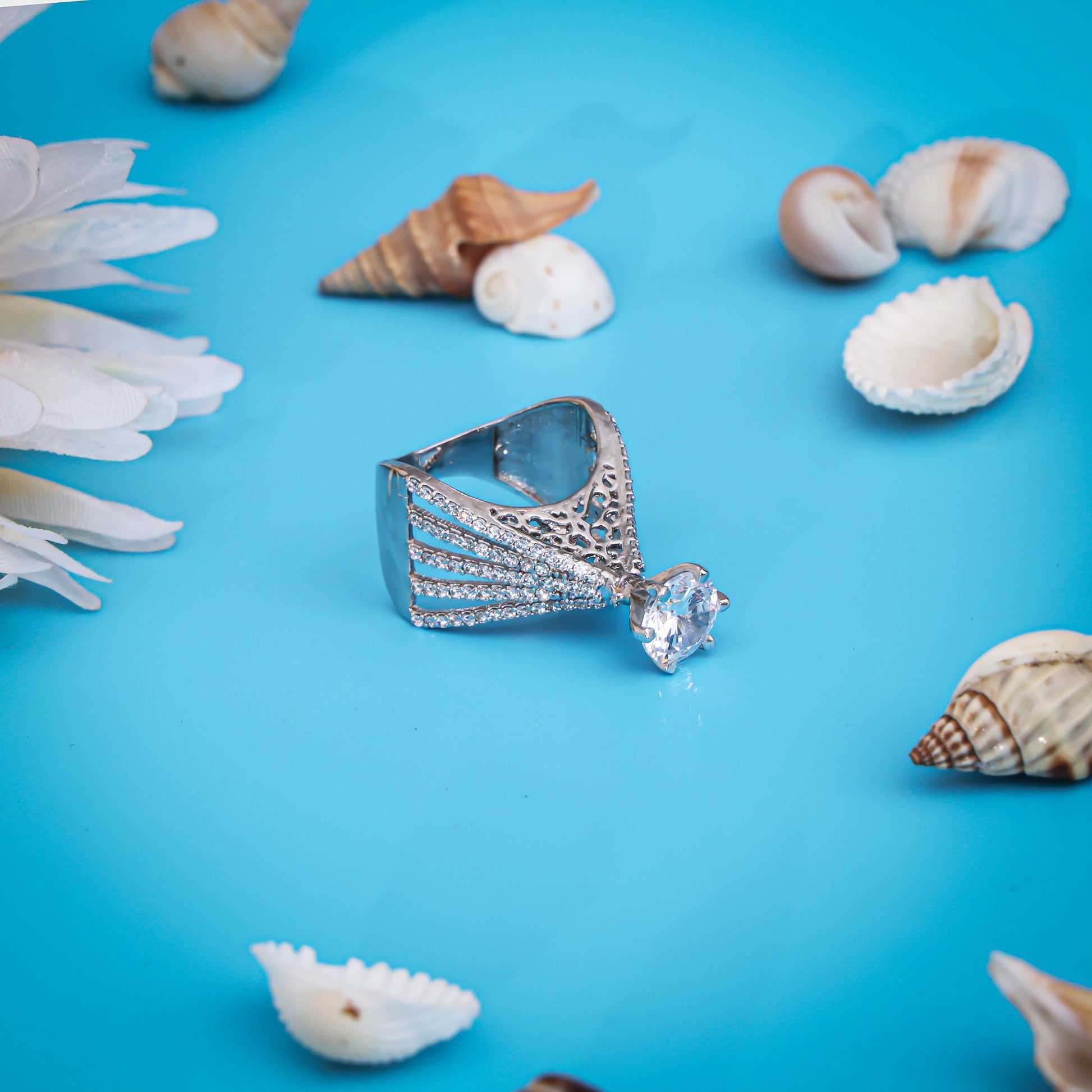 Hand-engraved silver ring featuring a shining white center stone for a distinctive look.