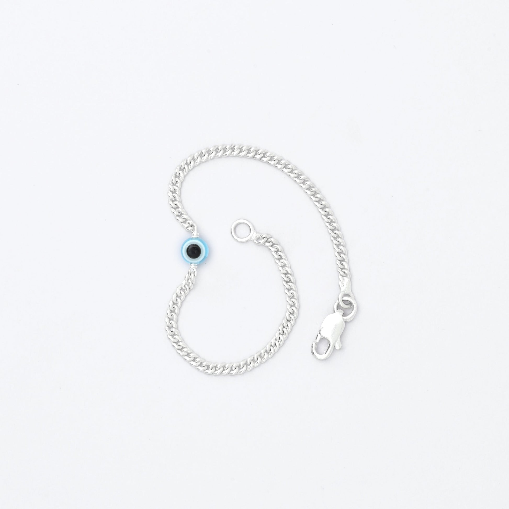 Silver bracelet with light blue evil eye charm for protection and fashion.