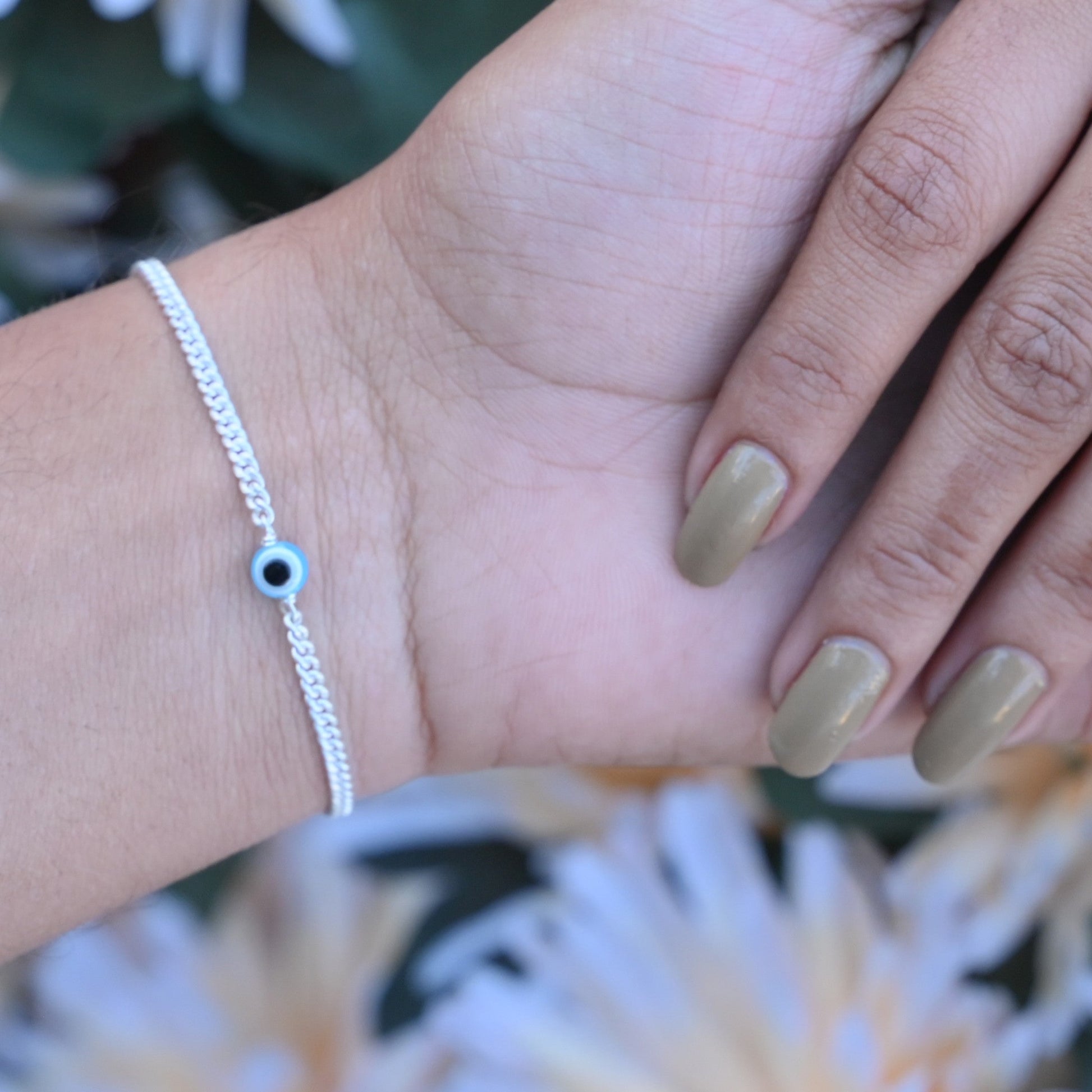 Light blue evil eye silver bracelet offering protection and style.